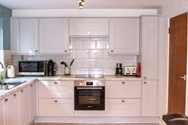 Spot the milk frother (one of my favorite things). Tall cupboard on right is pull out unit.