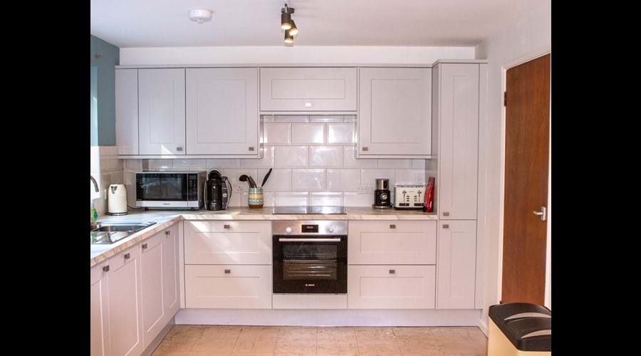 Spot the milk frother (one of my favorite things). Tall cupboard on right is pull out unit.