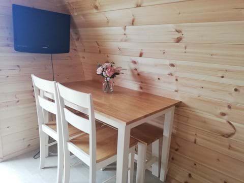 Dining table with seating for 4 and Freeview TV.