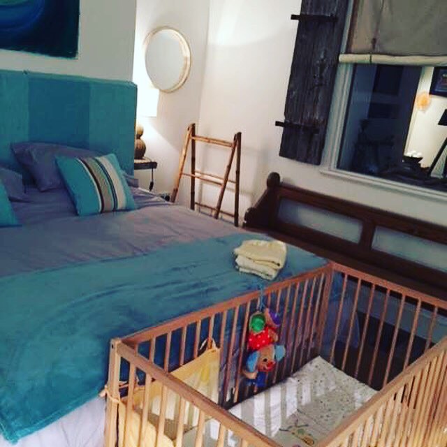 Wooden cot and bedding provided for babies at Chapel Bay Lodge