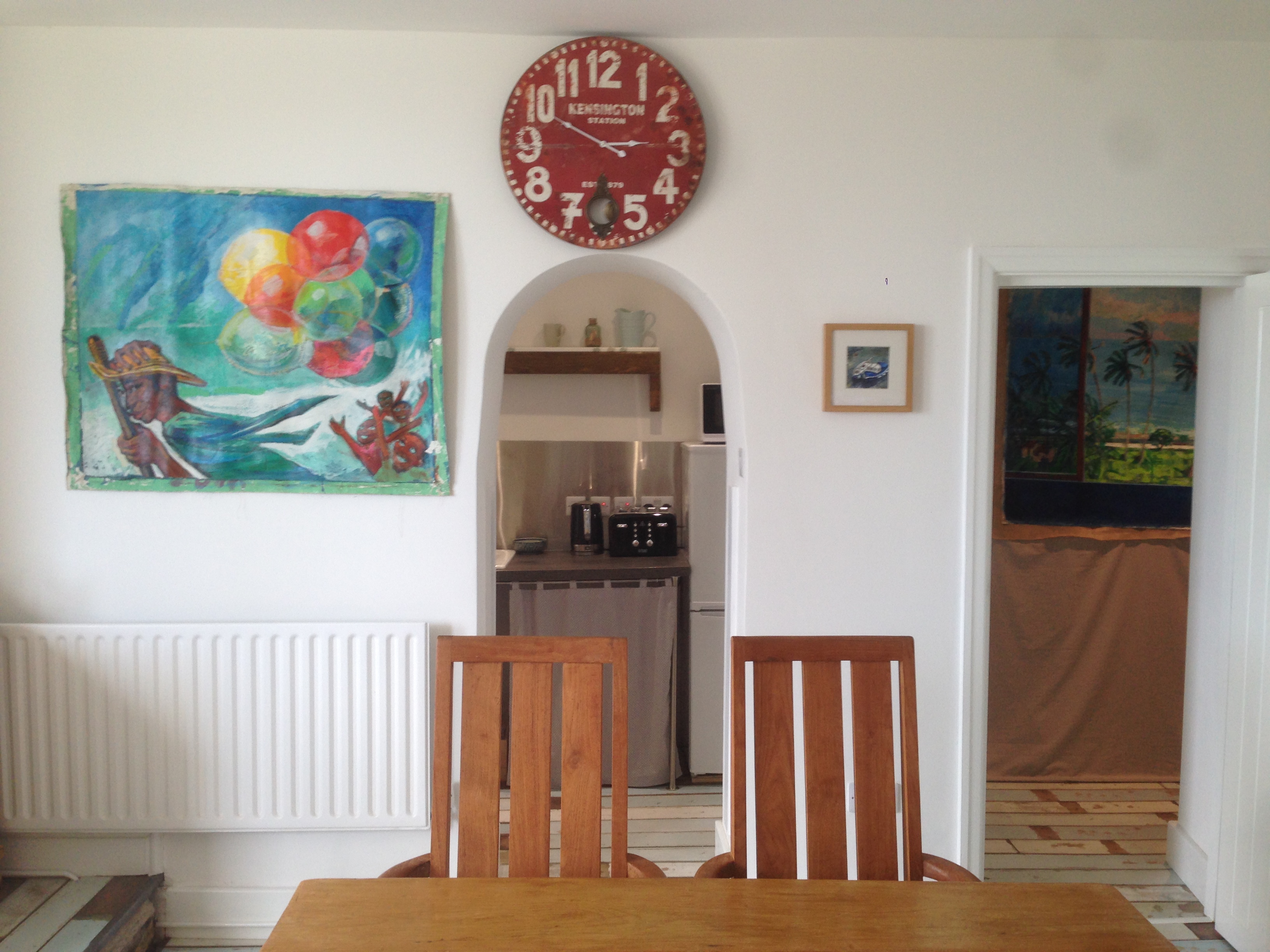 Dining table, archway to kitchen, doorway to internal hall leading to bathroom and bedroom