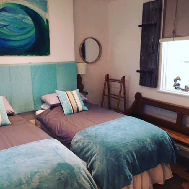 Chapel Bay Lodge bedroom with two single beds