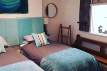 Chapel Bay Lodge bedroom with two single beds