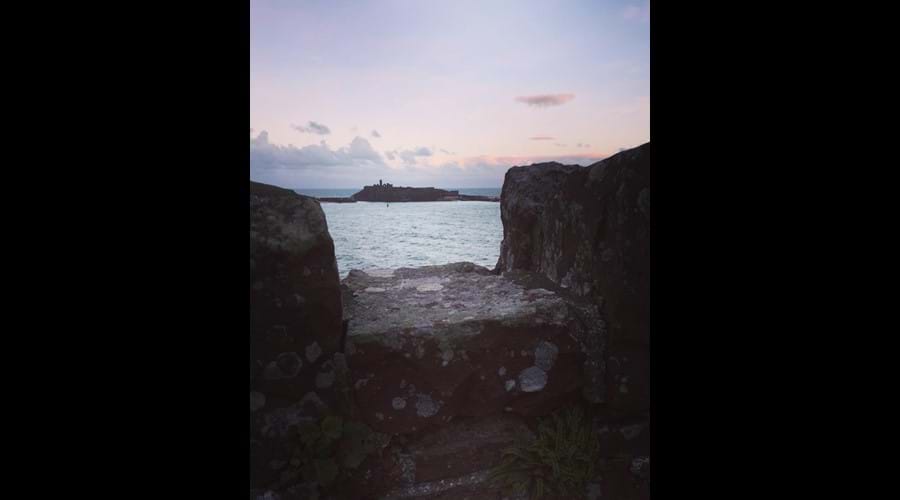 Pink morning skies above Peel Castle