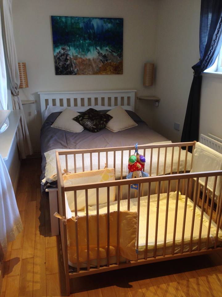 Wooden cot and bedding provided for babies at Bishop