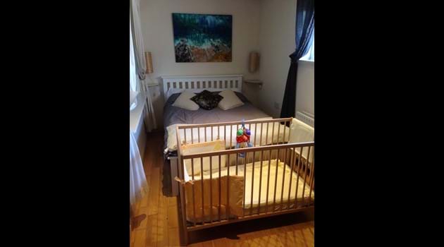 Wooden cot and bedding provided for babies at Bishop
