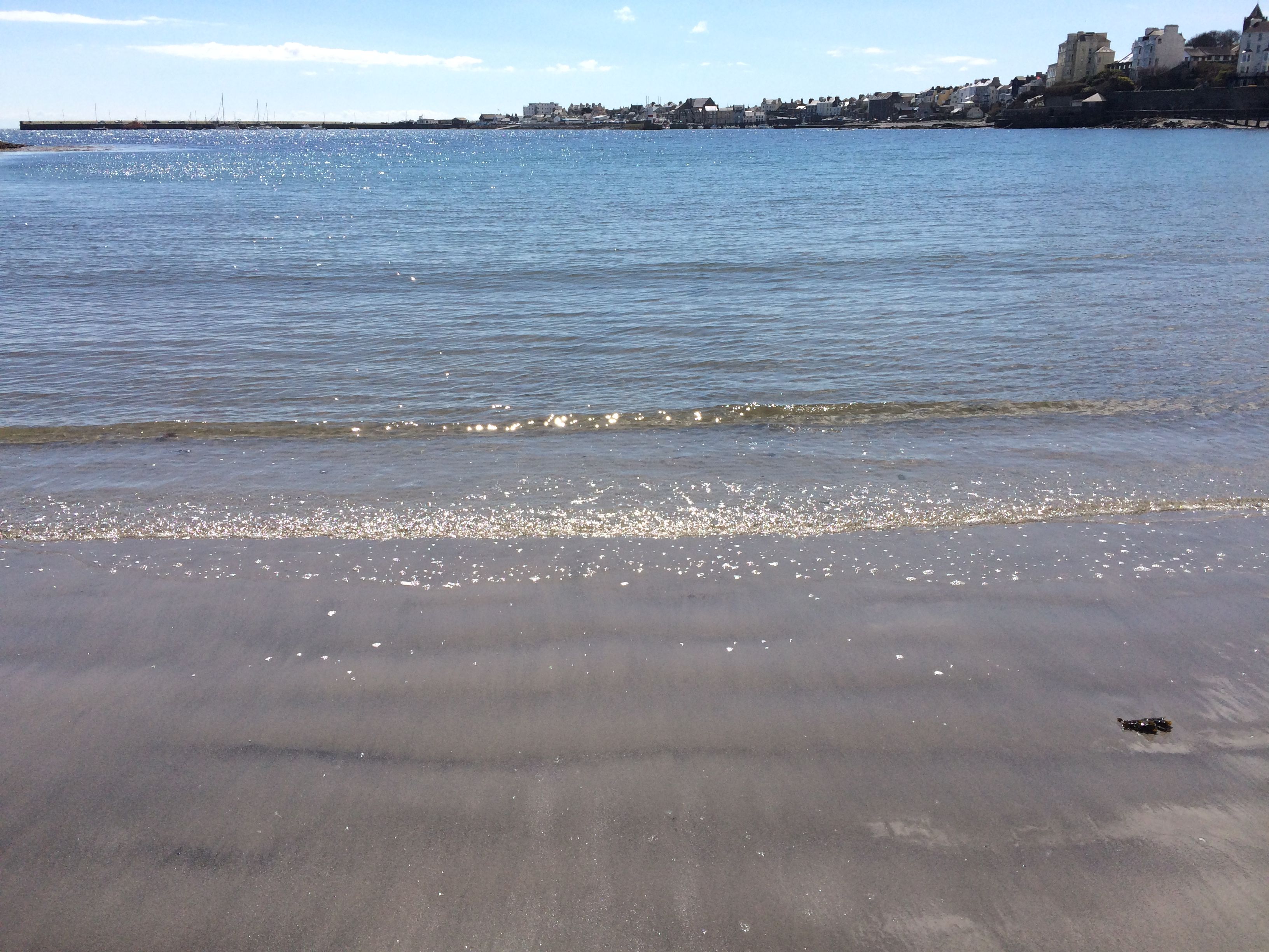 Shimmering sea on Chapel beach, Port St Mary