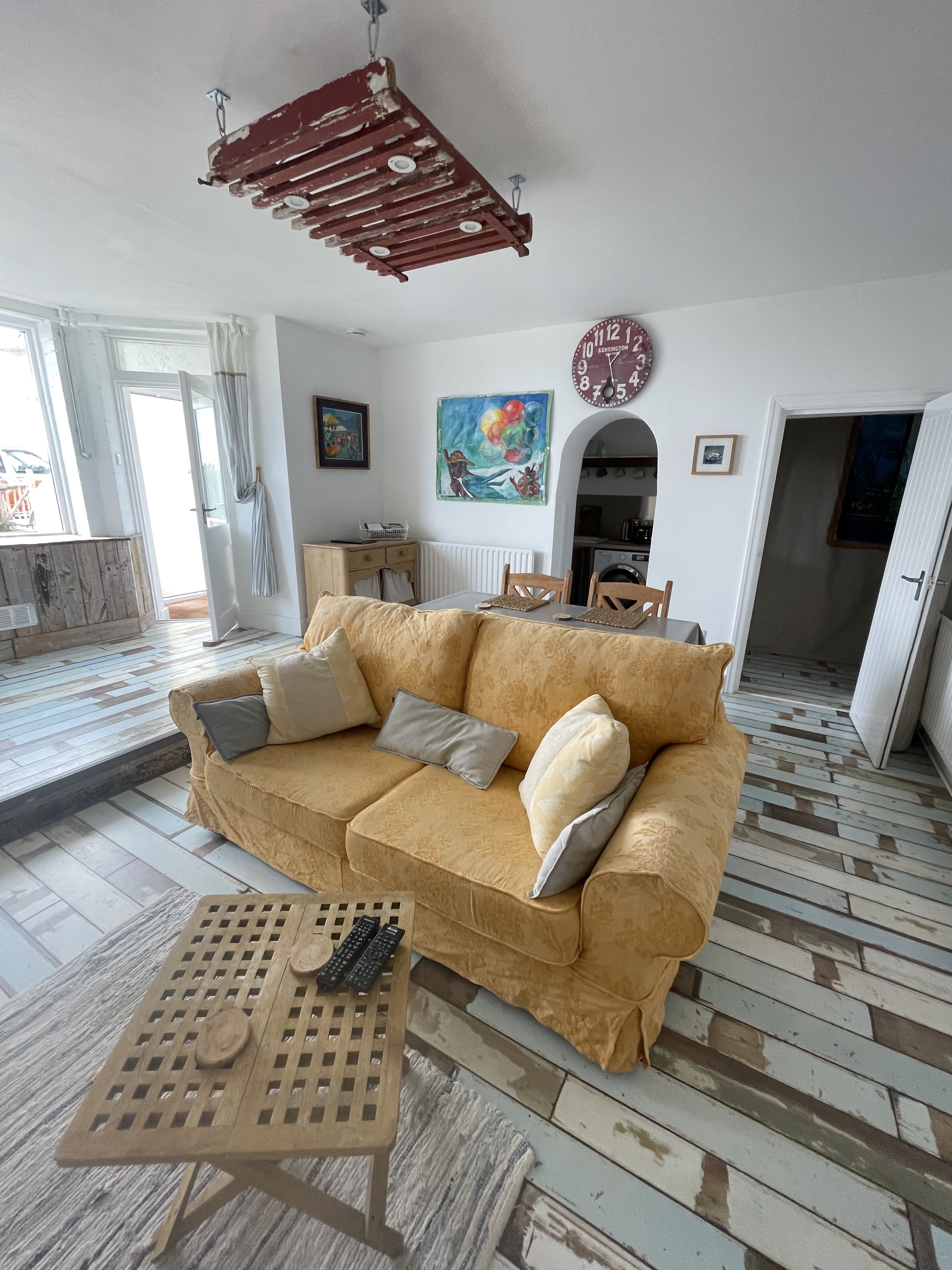 Lounge and dining area, with arched entrance to kitchen, doorway to inner hallway and bedroom