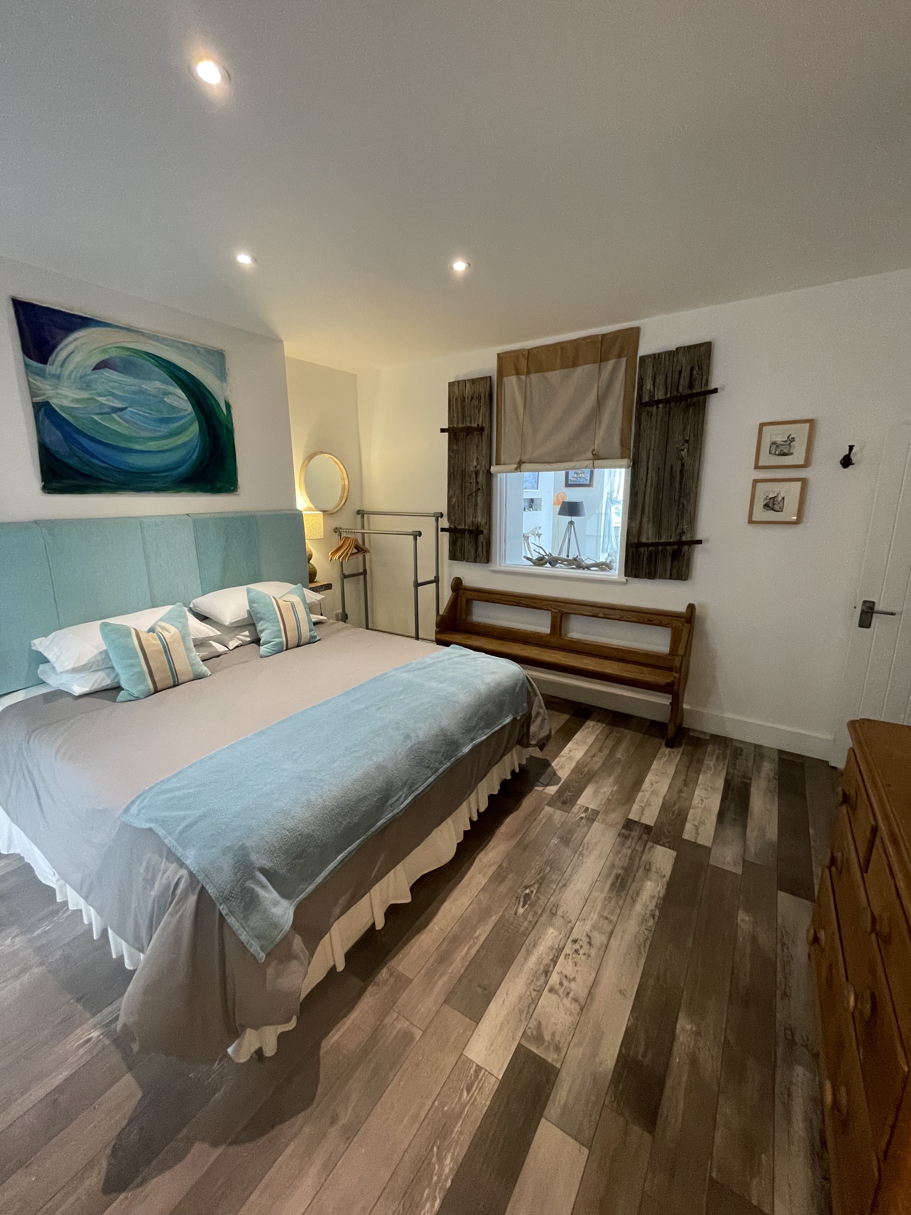 Bedroom with super king size bed, internal window through to lounge/dining area