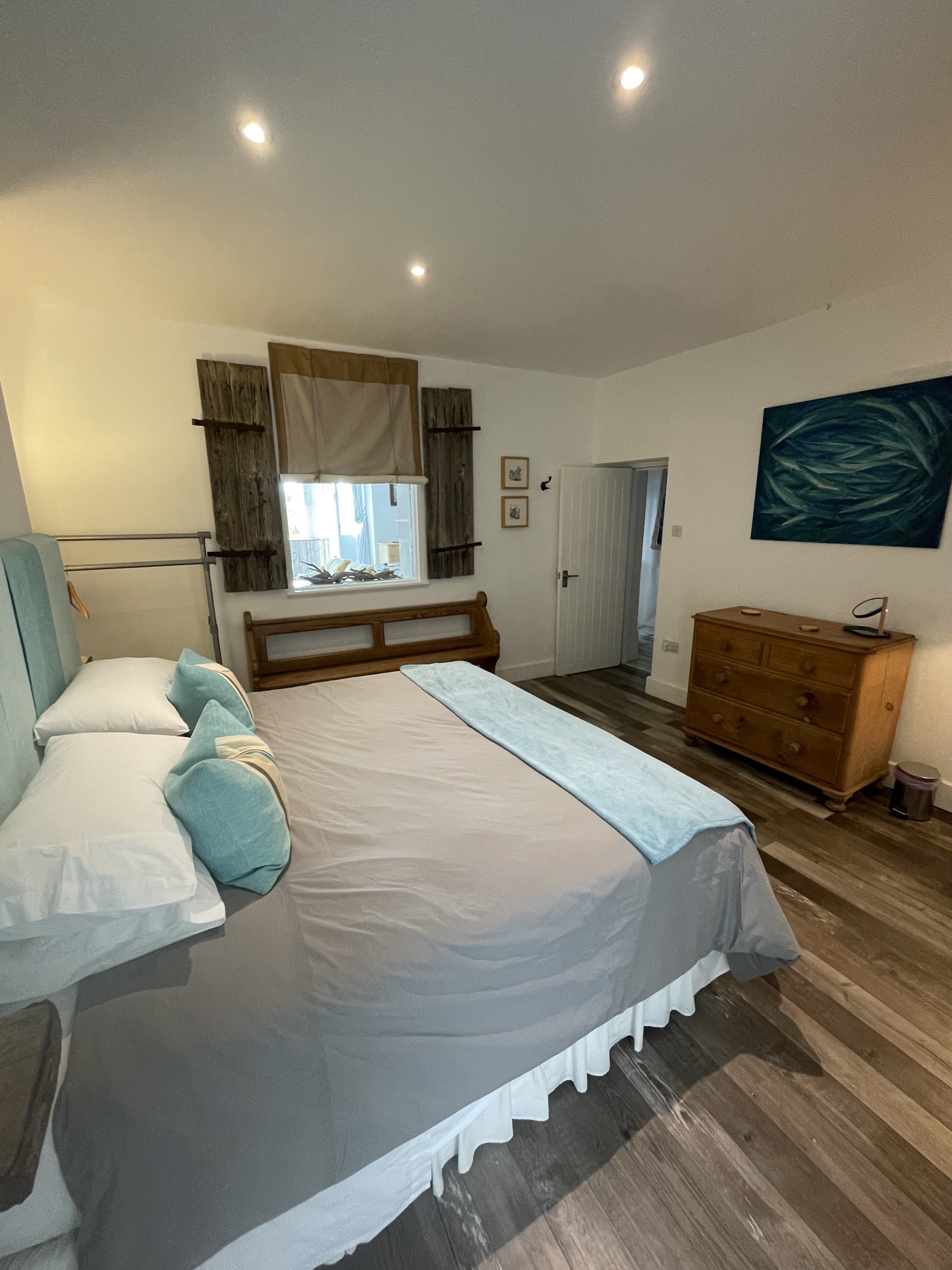 Bedroom with super king size bed, internal window through to lounge/dining area