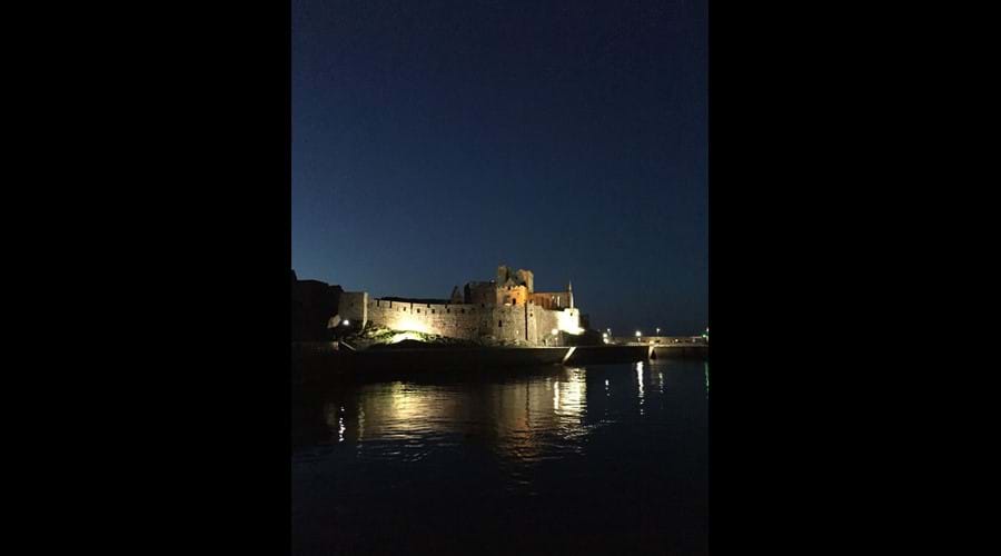 Peel Castle illuminated at dusk