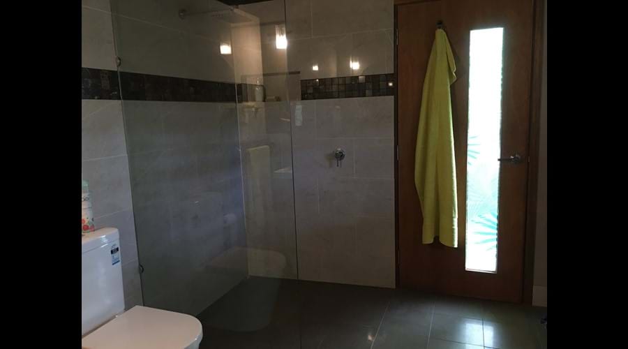 Large walk in shower with rainfall shower head....shower with a friend!