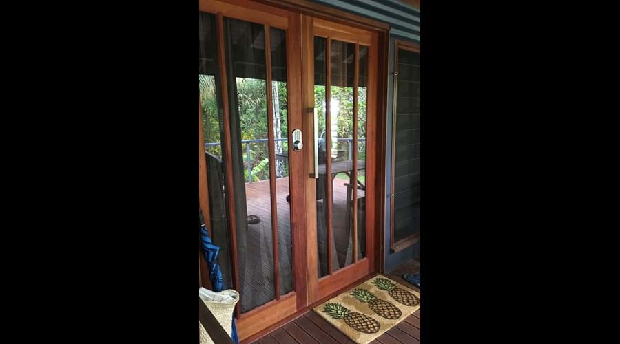 Bespoke Mahogany entrance doors with coded keypad entry.