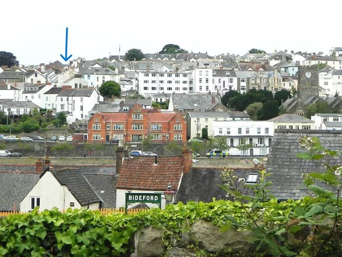 Looking across the river from the old station. The arrow shows the approximate cottage location.
