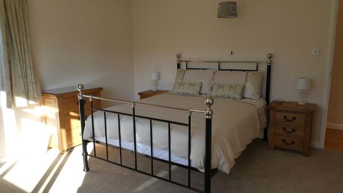 Master king size bedroom with dual aspect facing south overlooking the garden and view beyond