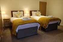 The larger bedroom can also be configured with two, full-sized single beds.