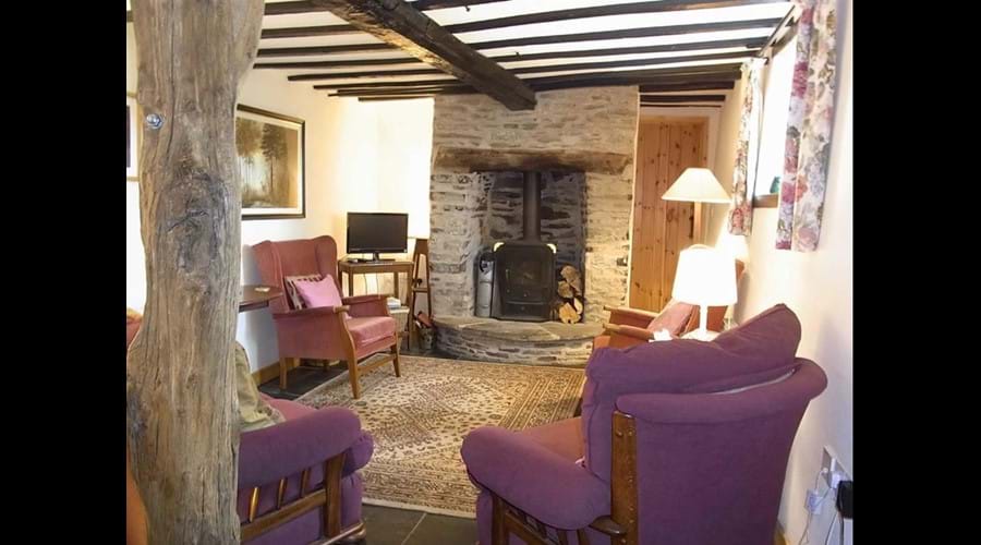 Living room with log burner, sofa and easy chairs