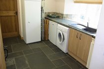 Utility room with washing machine, tumble dryer and boot dryer