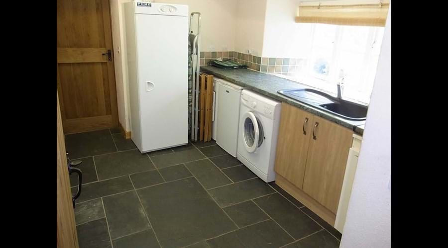 Utility room with washing machine, tumble dryer and boot dryer
