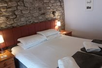 Room 4 (main pub building) Featuring a stone wall, can be configured as a twin or double and ensuite with a walk in shower