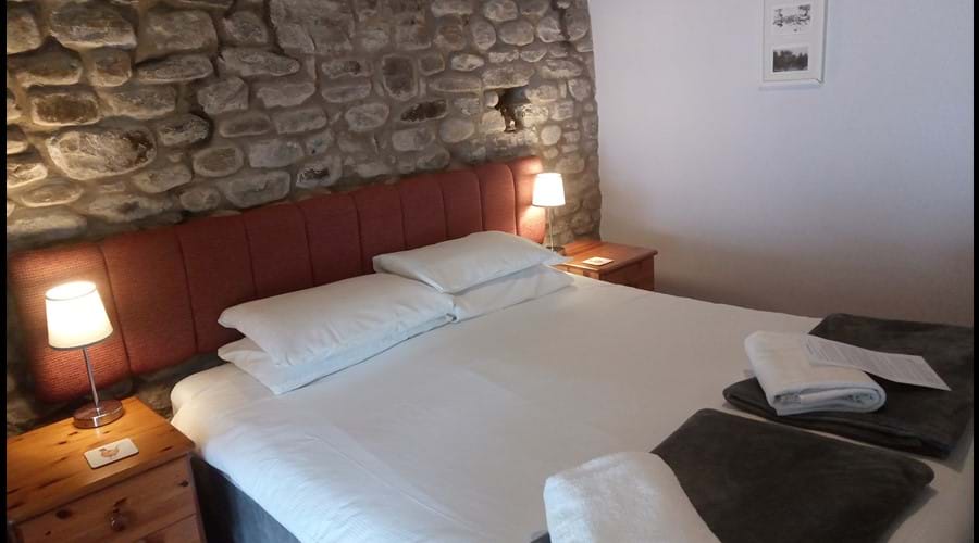 Room 4 (main pub building) Featuring a stone wall, can be configured as a twin or double and ensuite with a walk in shower