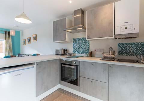 Fully fitted kitchen with induction hob, oven, fridge, microwave and everything you need for cooking and eating in