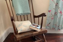 Relax with a book in the light-filled double bedroom upstairs
