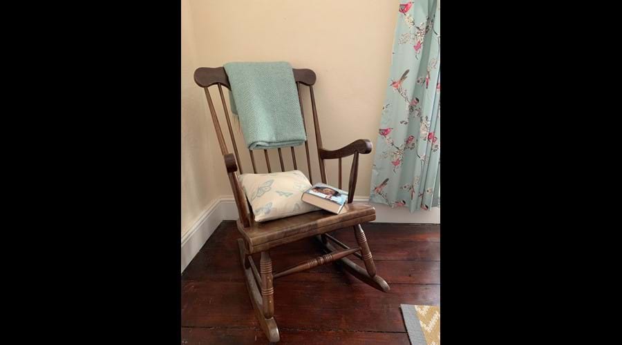 Relax with a book in the light-filled double bedroom upstairs