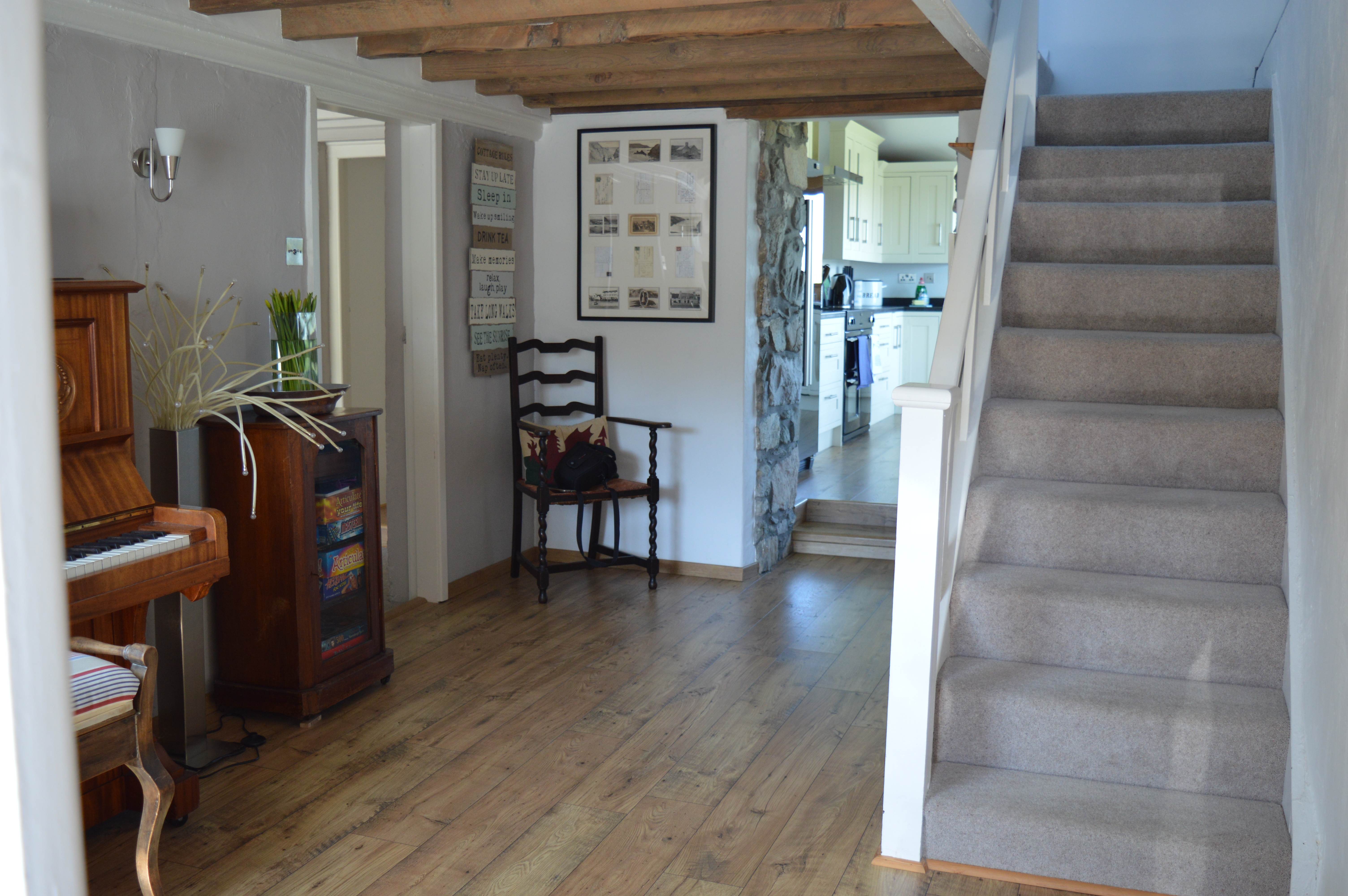 Hall with beams, piano and easy stairs to upper floor bedrooms and family bathroom