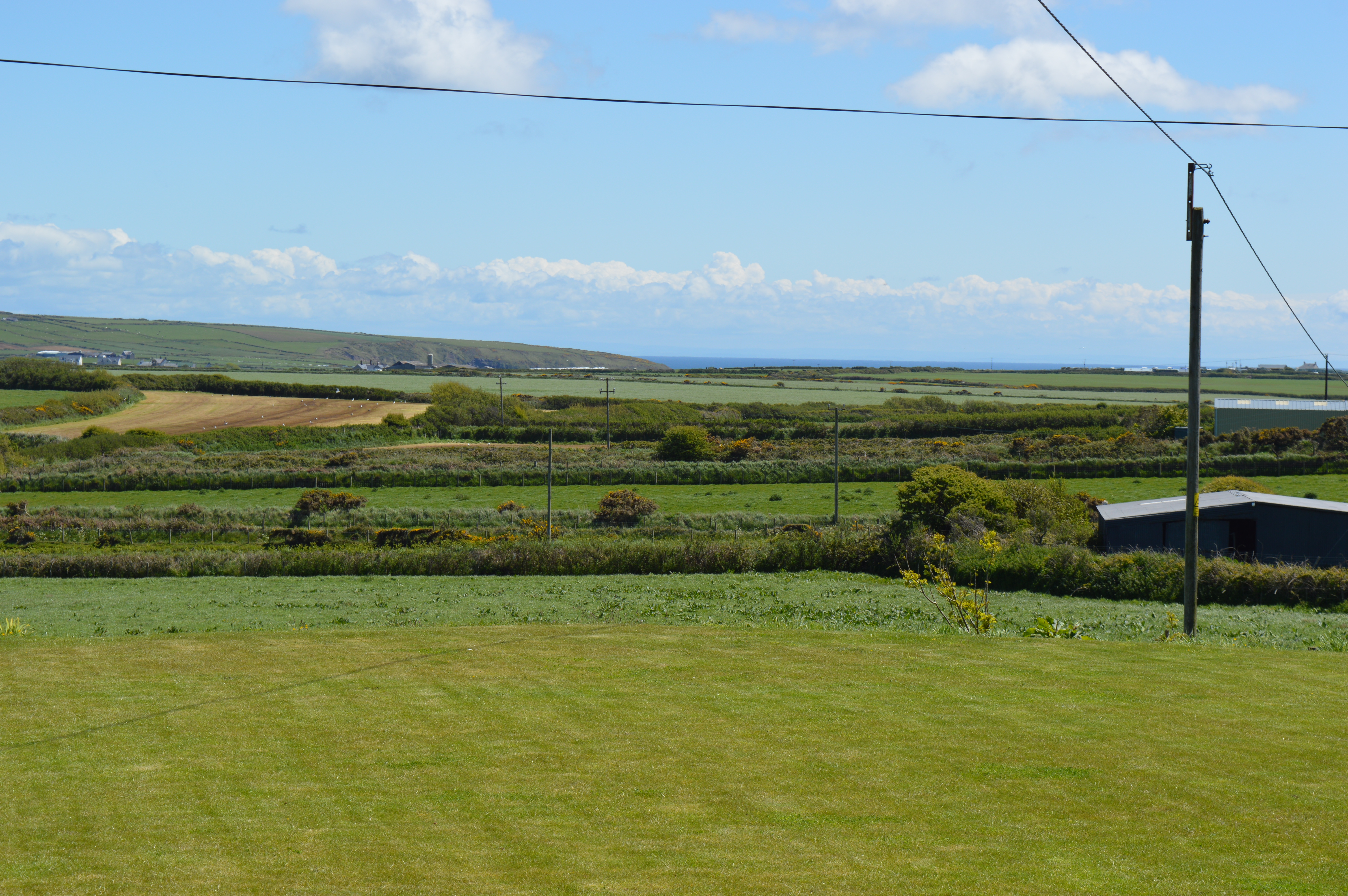 Extensive enclosed lawned area to rear of property, with spectacular sea, mountain and countryside views. 