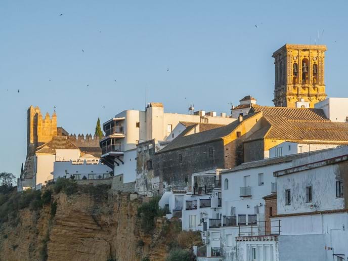 Gorgeous cliffside view of castle and whitewashed houses Photo