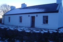 Front view of the cottage in the snow