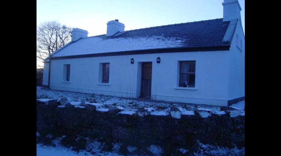 Front view of the cottage in the snow