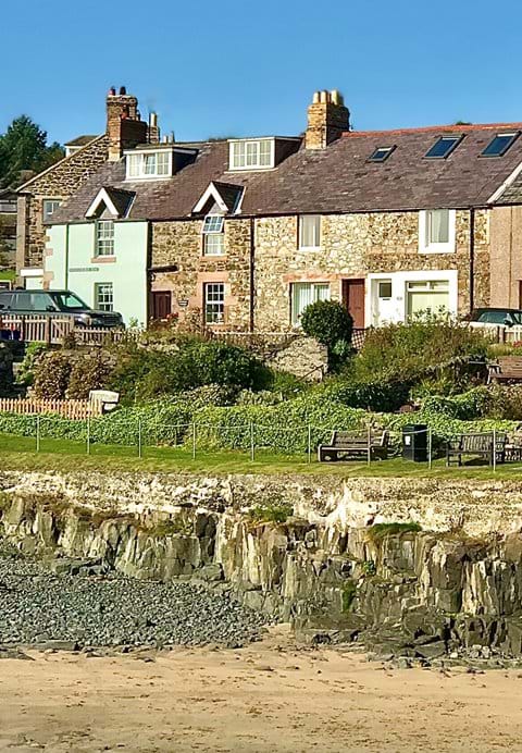 The second cottage from the left, in stone, overlooking the harbour beach 