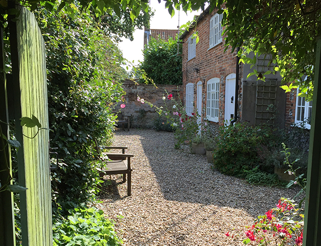 Walk through the secret gate to the peace and quiet of 8 Carpenters Cottages in the heart of Holt