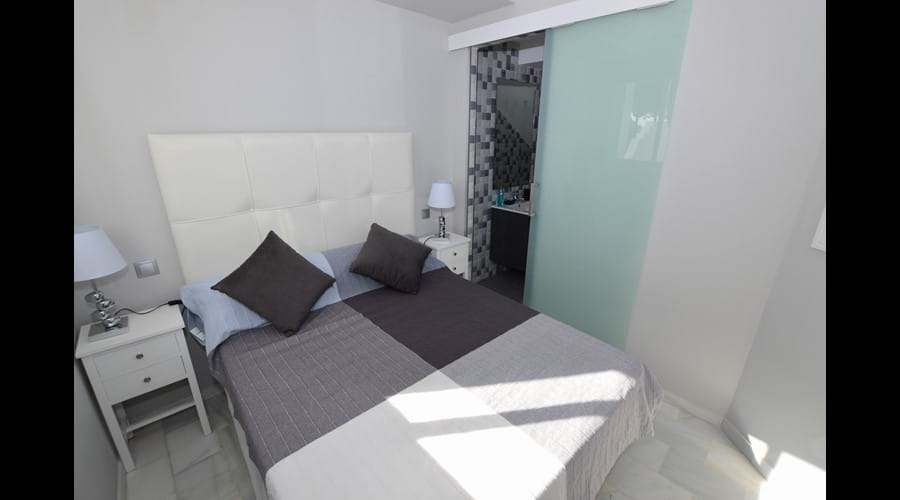 Guest bedroom with sliding door to ensuite