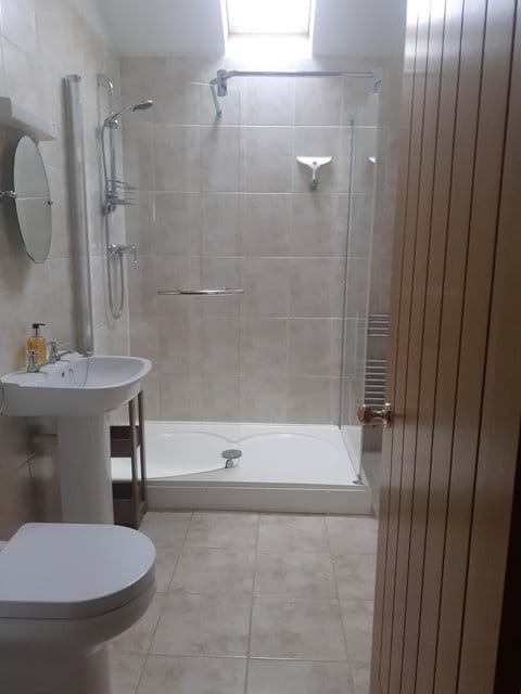 bathroom with shower and storage