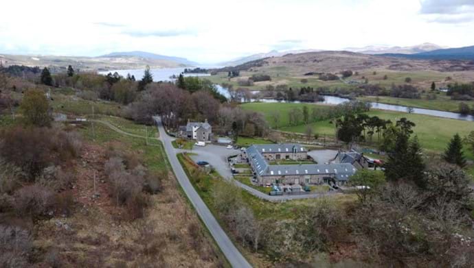 A drone shot of the Steadings development with Loch Rannoch in the background.