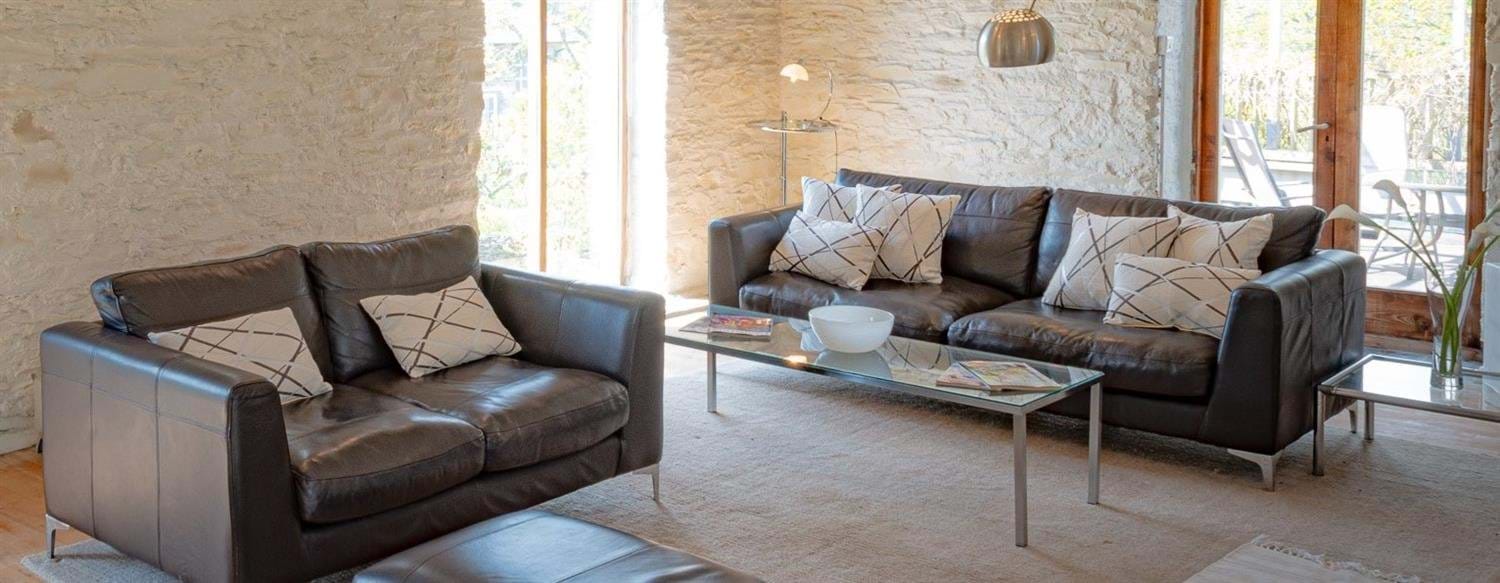 Two sofas, ottoman, coffee table, long windows