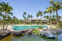 The pool complex includes a kiddie pool and a hot tub with its own rock waterfall