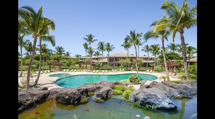 The pool complex includes a kiddie pool and a hot tub with its own rock waterfall