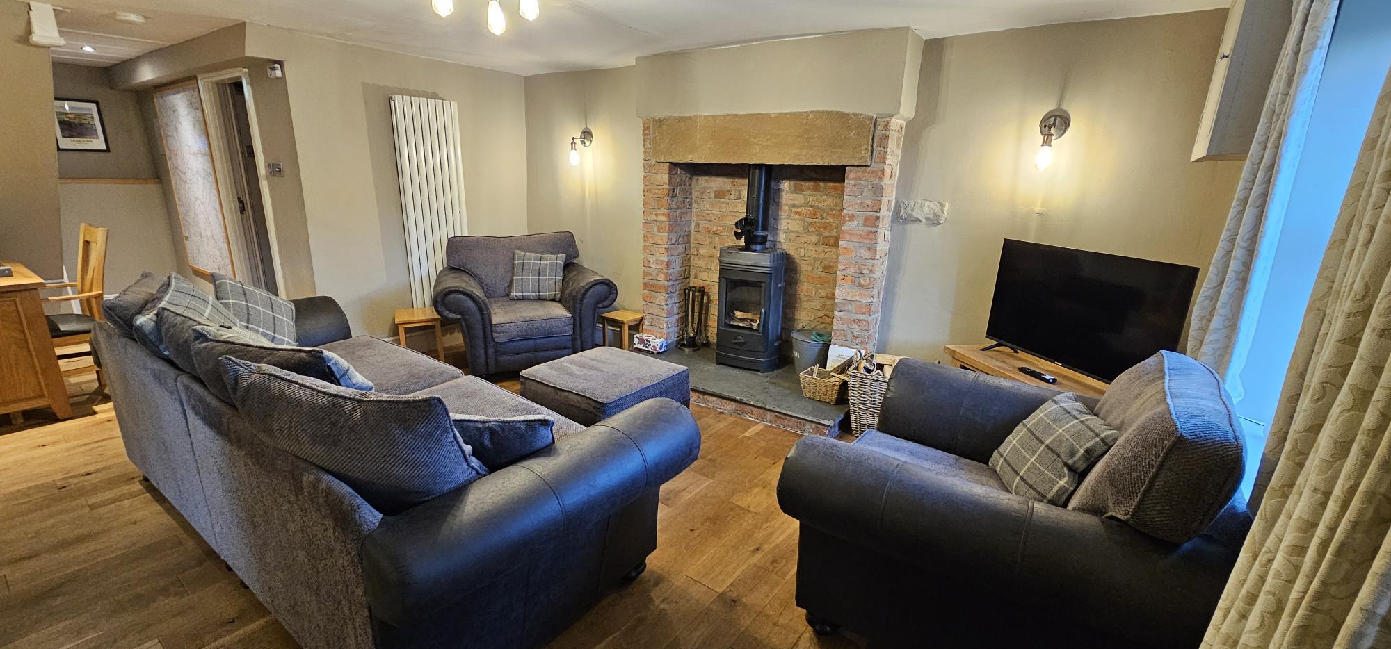 Cosy Lounge with Log Burner comfortably seating 8