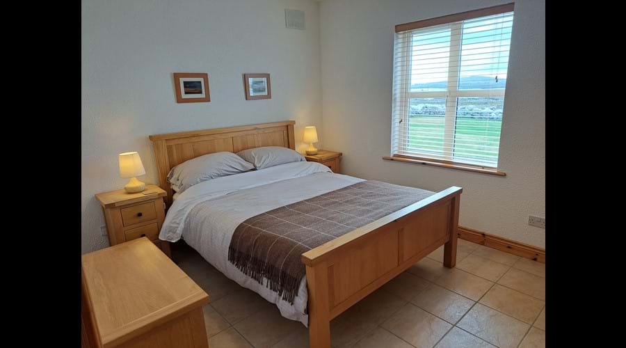 The kingsize bed in the downstairs bedroom