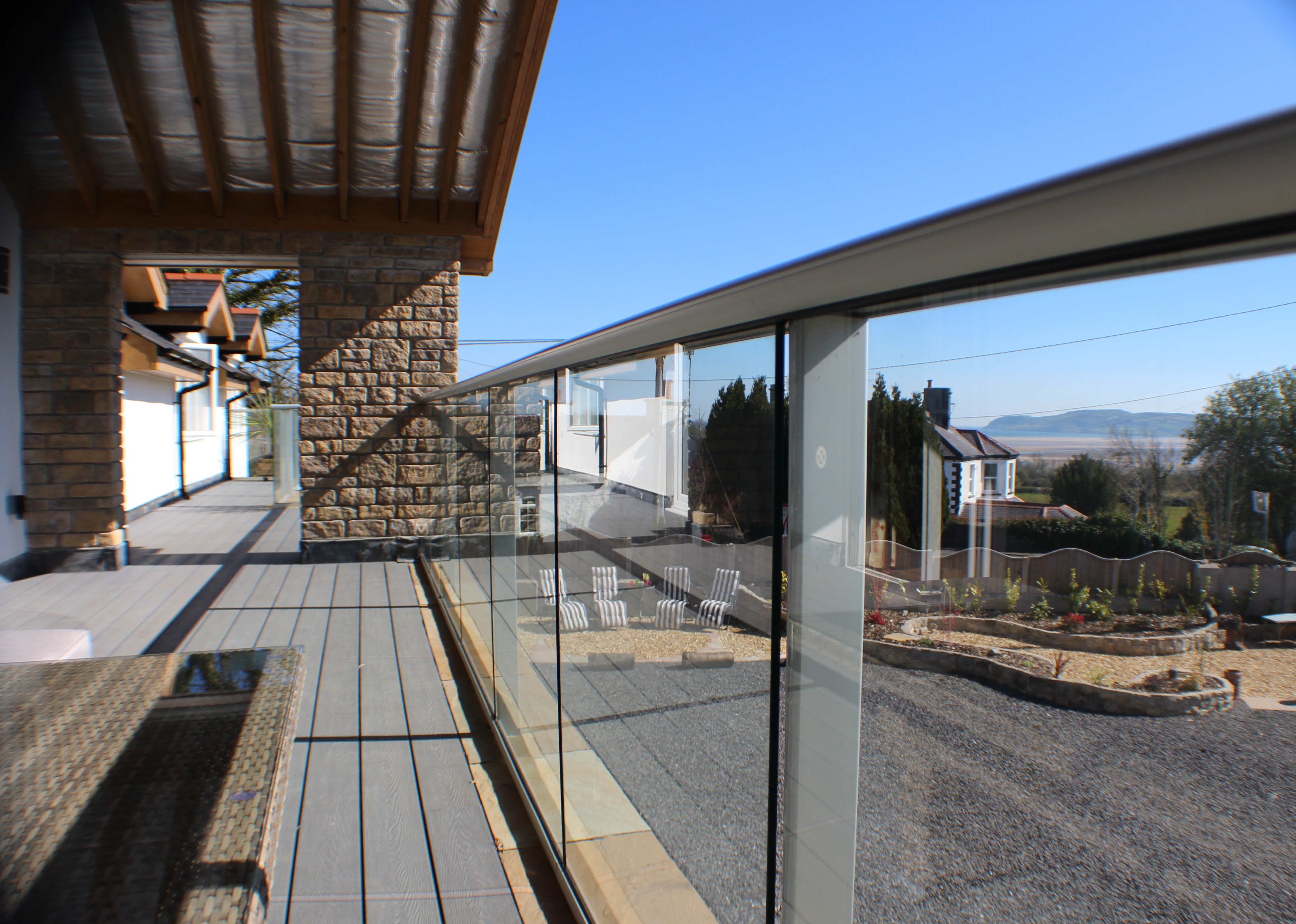 A picture taken from the balcony overlooking the front yard, with Red Wharf Bay seen in the background.