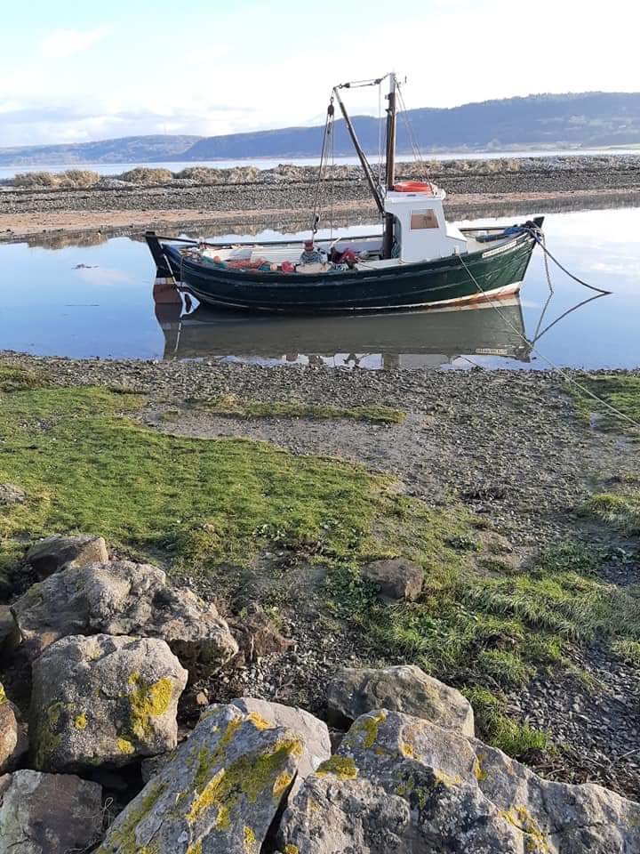 A picture of a boat in the water at Red Wharf Bay.