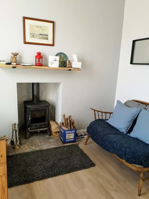 Enjoy the comfort of  the log burner from the two seater couch. 