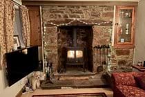 Cosy lounge with inglenook fireplace and log burner