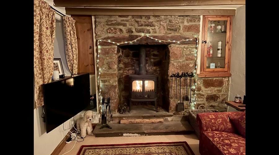Cosy lounge with inglenook fireplace and log burner
