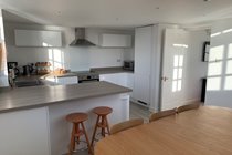 The bright well-equipped kitchen where the sun often streams in