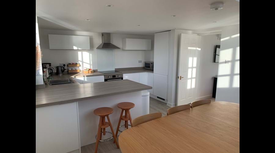 The bright well-equipped kitchen where the sun often streams in